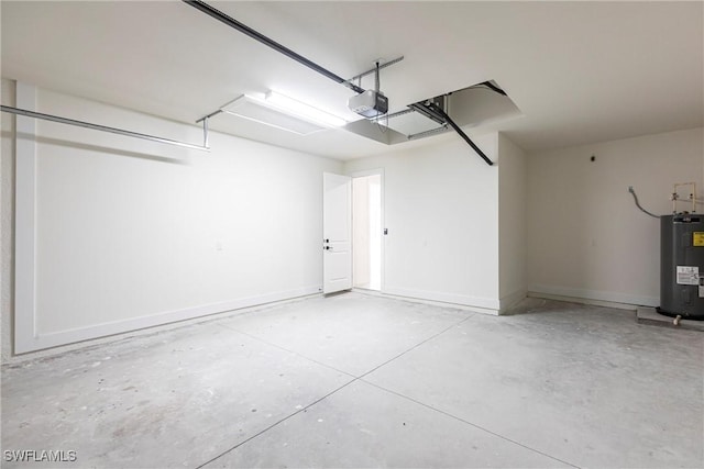 garage with a garage door opener, electric water heater, and baseboards