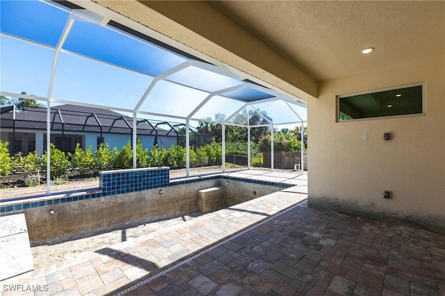 view of patio with glass enclosure