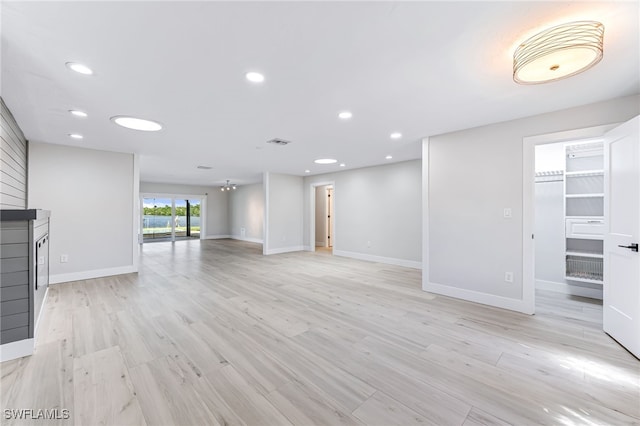 unfurnished living room featuring light wood finished floors, visible vents, and recessed lighting