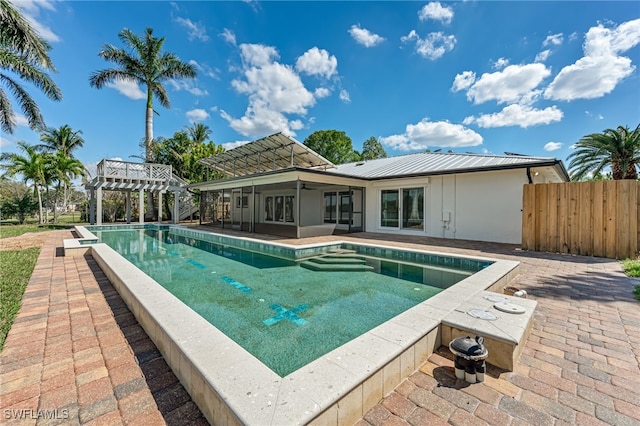 view of swimming pool featuring fence, a ceiling fan, a fenced in pool, a pergola, and a patio area