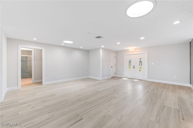 unfurnished living room featuring baseboards, visible vents, light wood-style flooring, and recessed lighting