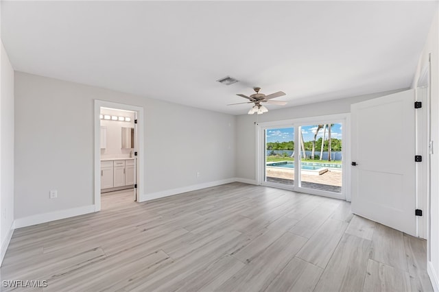 interior space with light wood-type flooring, baseboards, visible vents, and ceiling fan