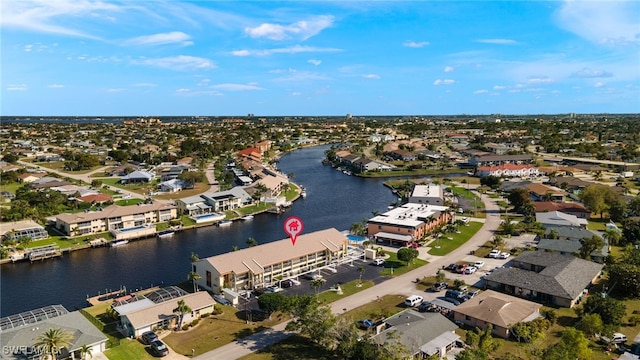 drone / aerial view featuring a residential view and a water view