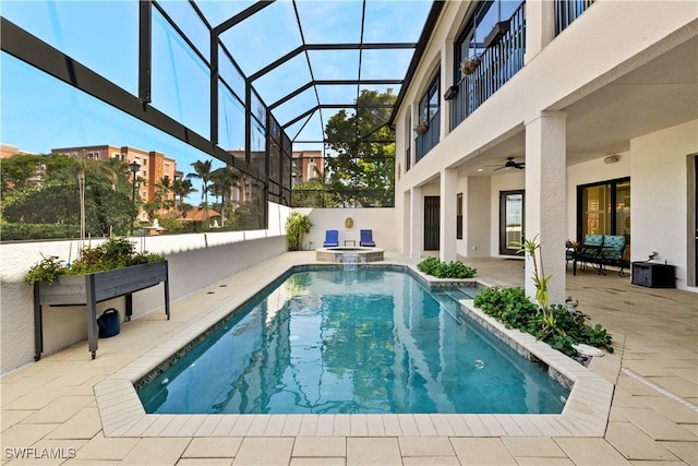 view of pool with a ceiling fan, a pool with connected hot tub, a lanai, and a patio