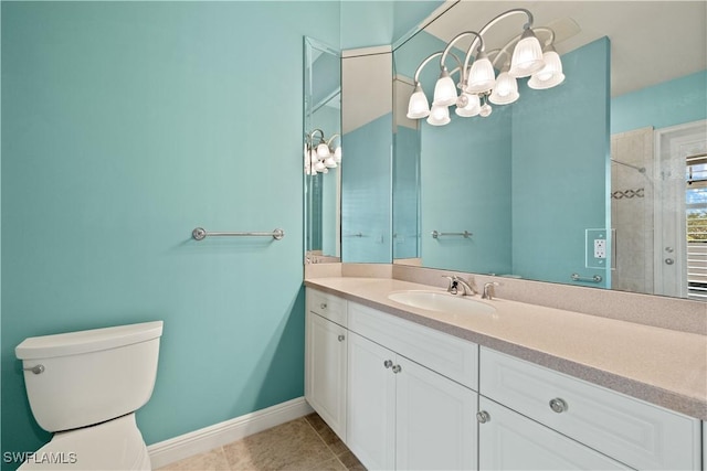 bathroom with toilet, vanity, baseboards, and tile patterned floors