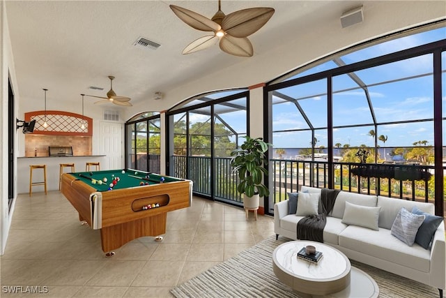 playroom with a healthy amount of sunlight, visible vents, ceiling fan, and light tile patterned flooring