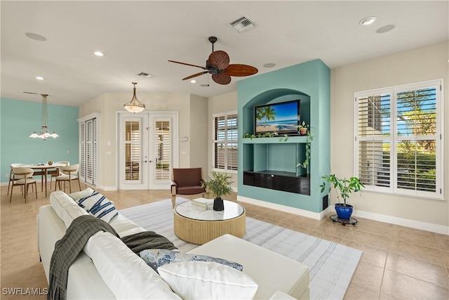 living area featuring recessed lighting, french doors, and visible vents