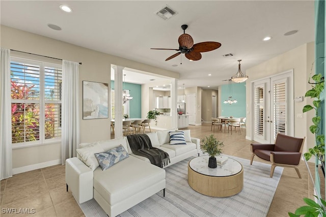 living room with light tile patterned floors, visible vents, and recessed lighting