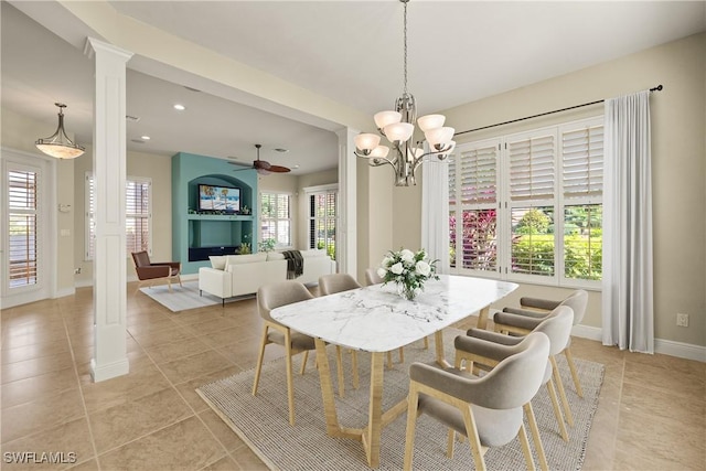 dining space with decorative columns, baseboards, ceiling fan with notable chandelier, light tile patterned flooring, and recessed lighting