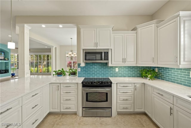 kitchen featuring white cabinetry, light stone counters, stainless steel appliances, and decorative backsplash