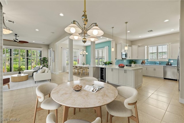 dining space with beverage cooler, light tile patterned flooring, visible vents, and recessed lighting