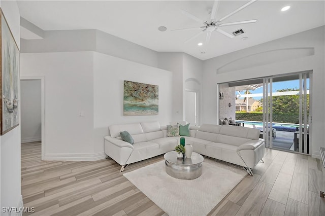 living area featuring light wood-style floors, recessed lighting, visible vents, and baseboards