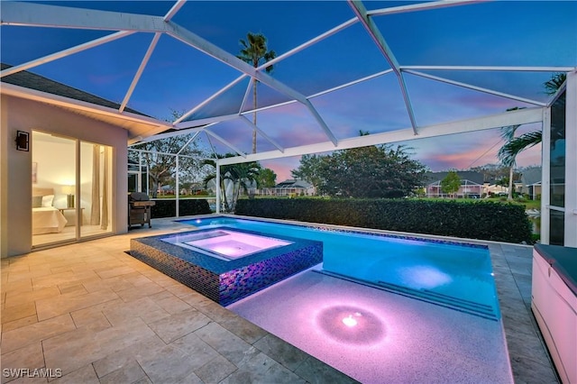 view of pool featuring a patio, grilling area, a lanai, and a pool with connected hot tub