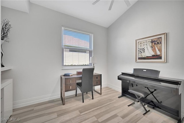 home office featuring lofted ceiling, a ceiling fan, light wood-style flooring, and baseboards