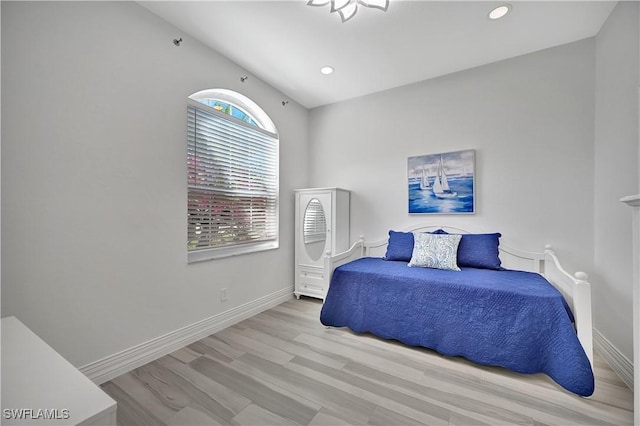 bedroom with light wood-style floors, recessed lighting, and baseboards