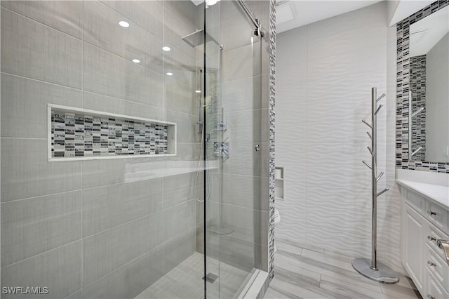 full bathroom featuring vanity and a shower stall