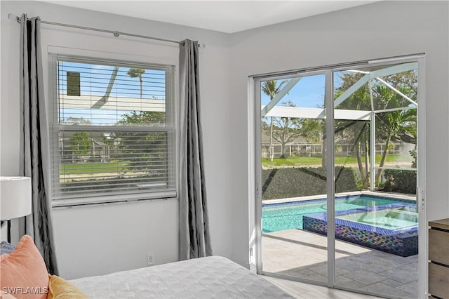 bedroom with access to outside and multiple windows