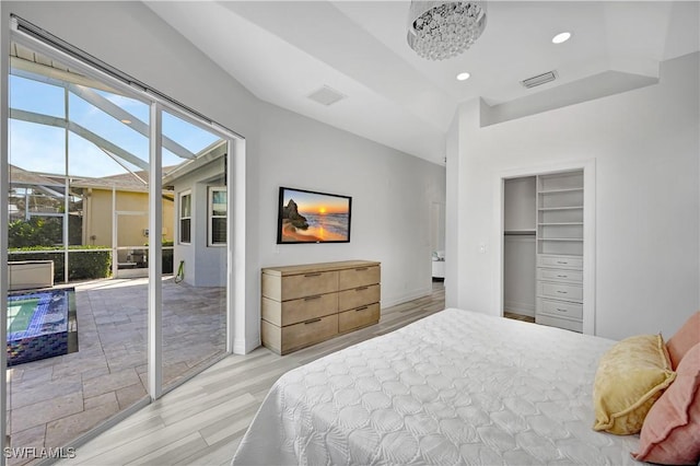 bedroom with recessed lighting, a closet, visible vents, wood finished floors, and access to outside