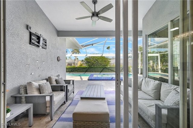 sunroom / solarium featuring ceiling fan