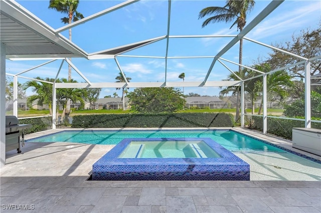 view of swimming pool featuring glass enclosure, a pool with connected hot tub, and a patio