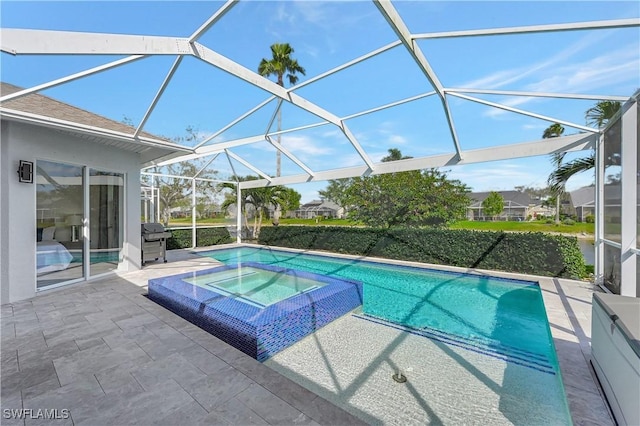 view of swimming pool with glass enclosure, a patio, area for grilling, and a pool with connected hot tub