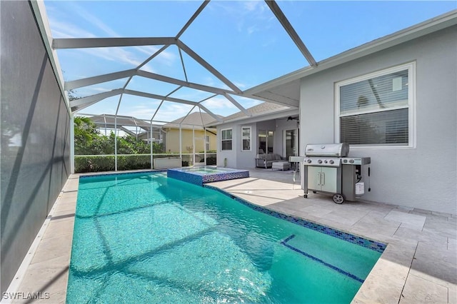 view of pool featuring a patio, a pool with connected hot tub, a ceiling fan, glass enclosure, and a grill