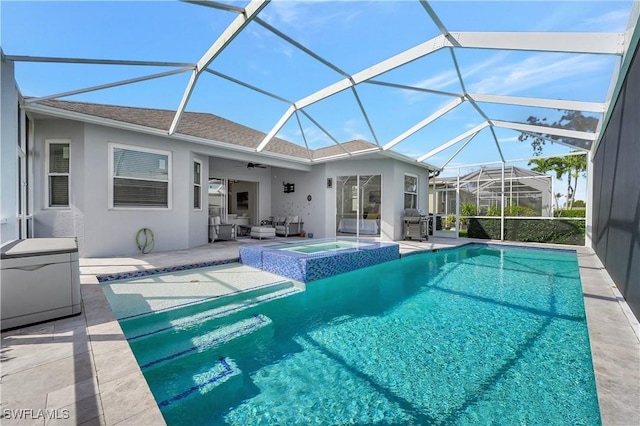 view of pool featuring ceiling fan, glass enclosure, outdoor lounge area, and a patio area