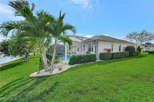 view of side of home featuring glass enclosure, an outdoor pool, a lawn, and stucco siding