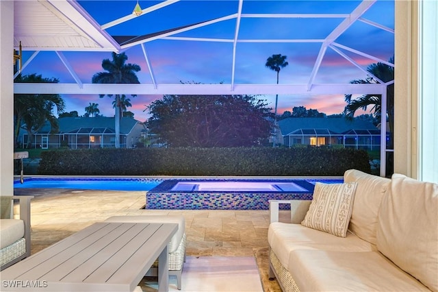 pool at dusk featuring a patio area, an outdoor pool, an outdoor living space, and an in ground hot tub