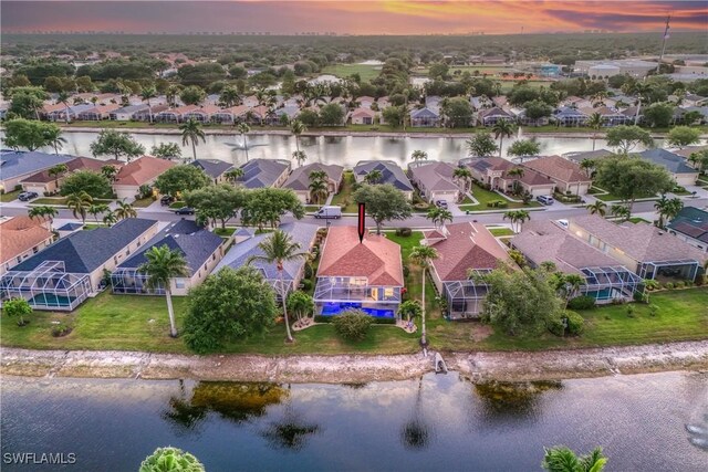 8074 Tauren Ct, Naples, FL 34119 - aerial view at dusk with a water view and a residential view