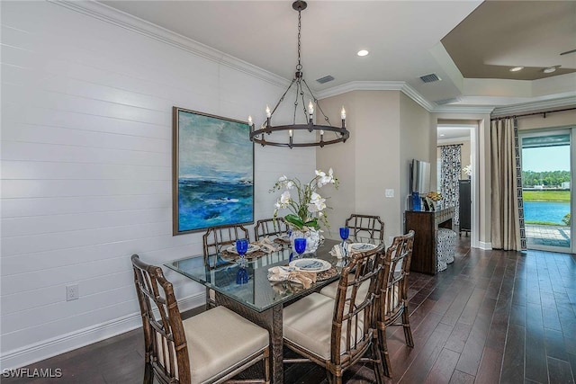 dining space with dark wood-style flooring, visible vents, ornamental molding, a chandelier, and baseboards