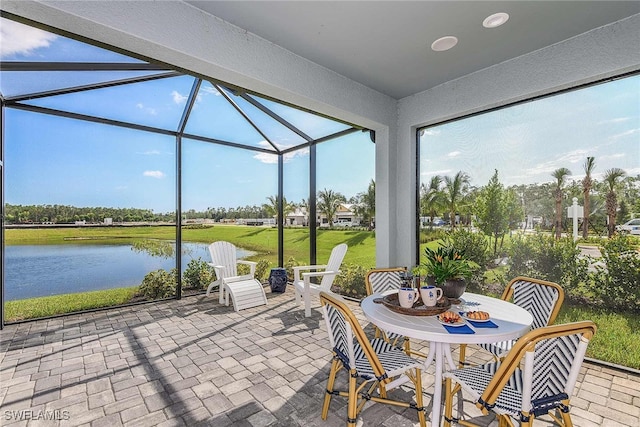 sunroom / solarium featuring a water view and plenty of natural light
