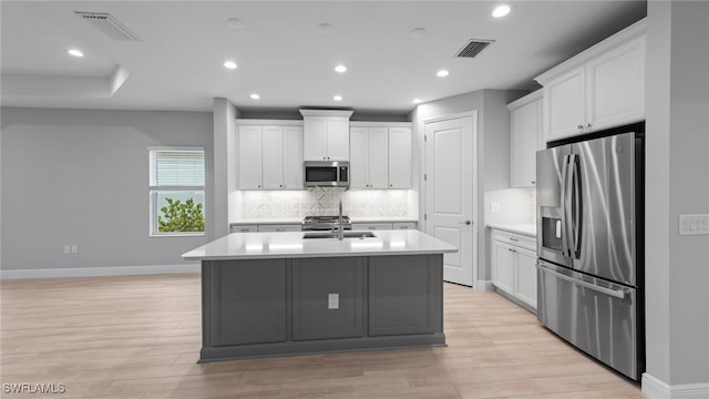 4640 Skysail Dr, Naples, FL 34120 - kitchen featuring stainless steel appliances, light wood-style flooring, backsplash, light countertops, and baseboards