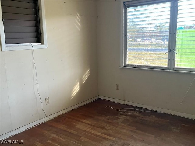 unfurnished room with wood finished floors