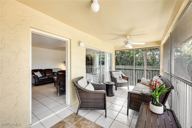 sunroom / solarium with a ceiling fan