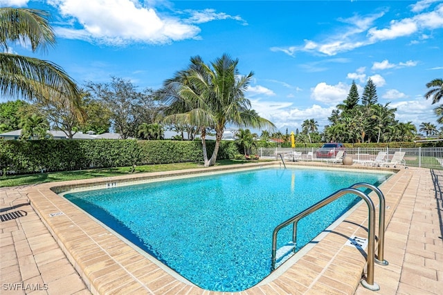 pool with fence and a patio