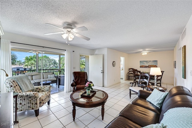 living room with visible vents, ceiling fan, a textured ceiling, and light tile patterned floors