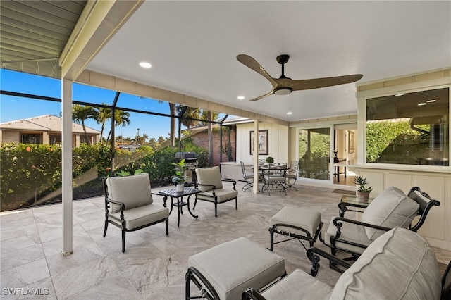 view of patio / terrace featuring glass enclosure, an outdoor living space, and ceiling fan