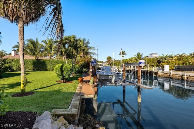 view of dock featuring boat lift, a yard, and a water view