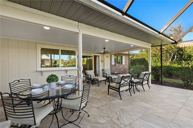 view of patio / terrace with outdoor dining space and a lanai