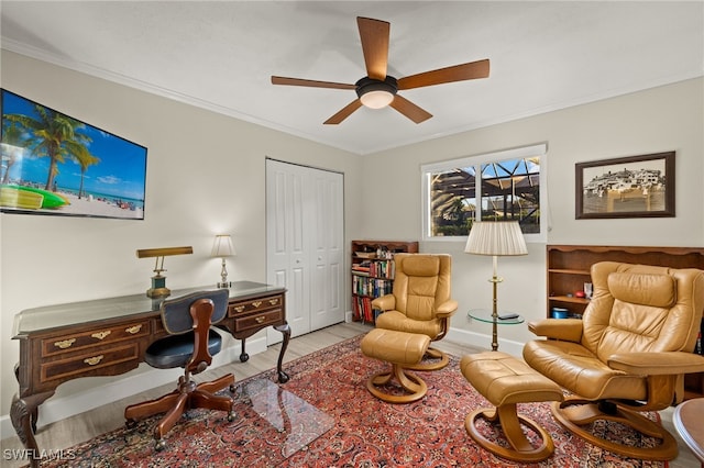 office space featuring ceiling fan, baseboards, wood finished floors, and ornamental molding