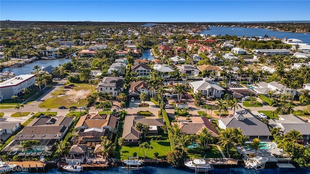 drone / aerial view featuring a residential view and a water view