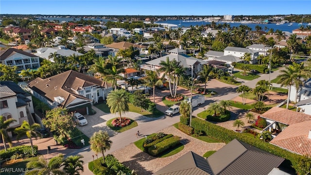 drone / aerial view featuring a residential view and a water view