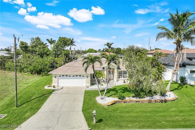 view of front of house with concrete driveway, a front lawn, and an attached garage