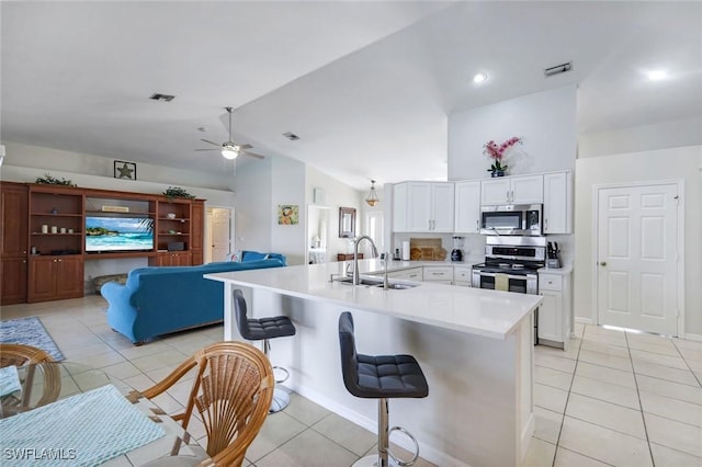 kitchen featuring light tile patterned floors, stainless steel appliances, light countertops, visible vents, and a sink