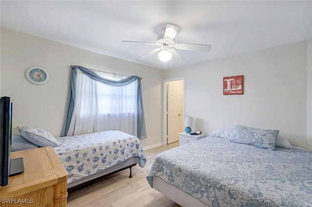 bedroom featuring light wood finished floors and a ceiling fan