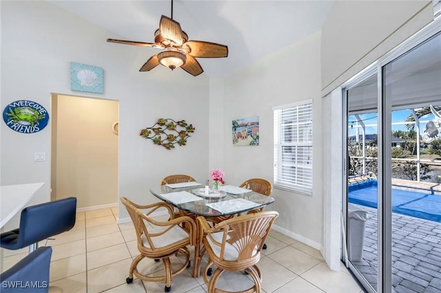 dining room with light tile patterned flooring, ceiling fan, and baseboards