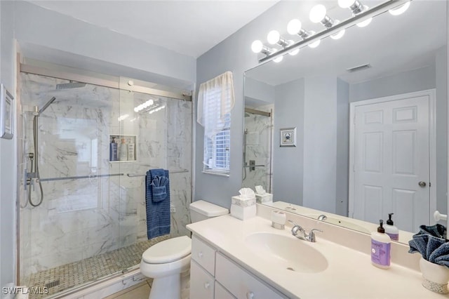 bathroom featuring toilet, a marble finish shower, visible vents, and vanity