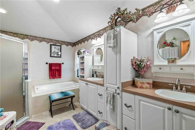 bathroom featuring a sink, a stall shower, tile patterned floors, and a bath