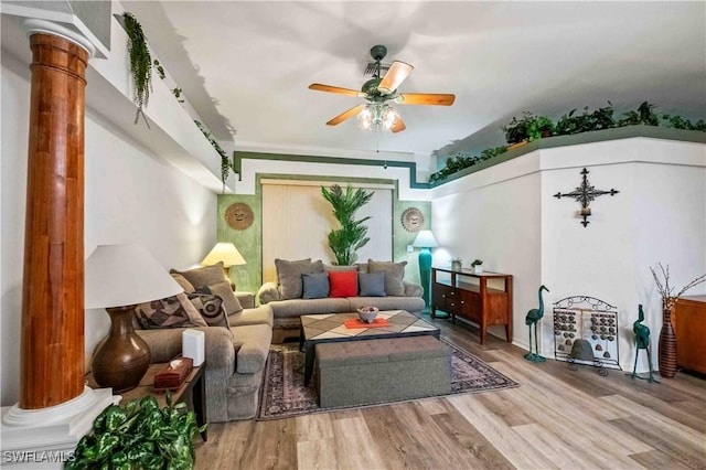 living area with wood finished floors, ornate columns, and ceiling fan